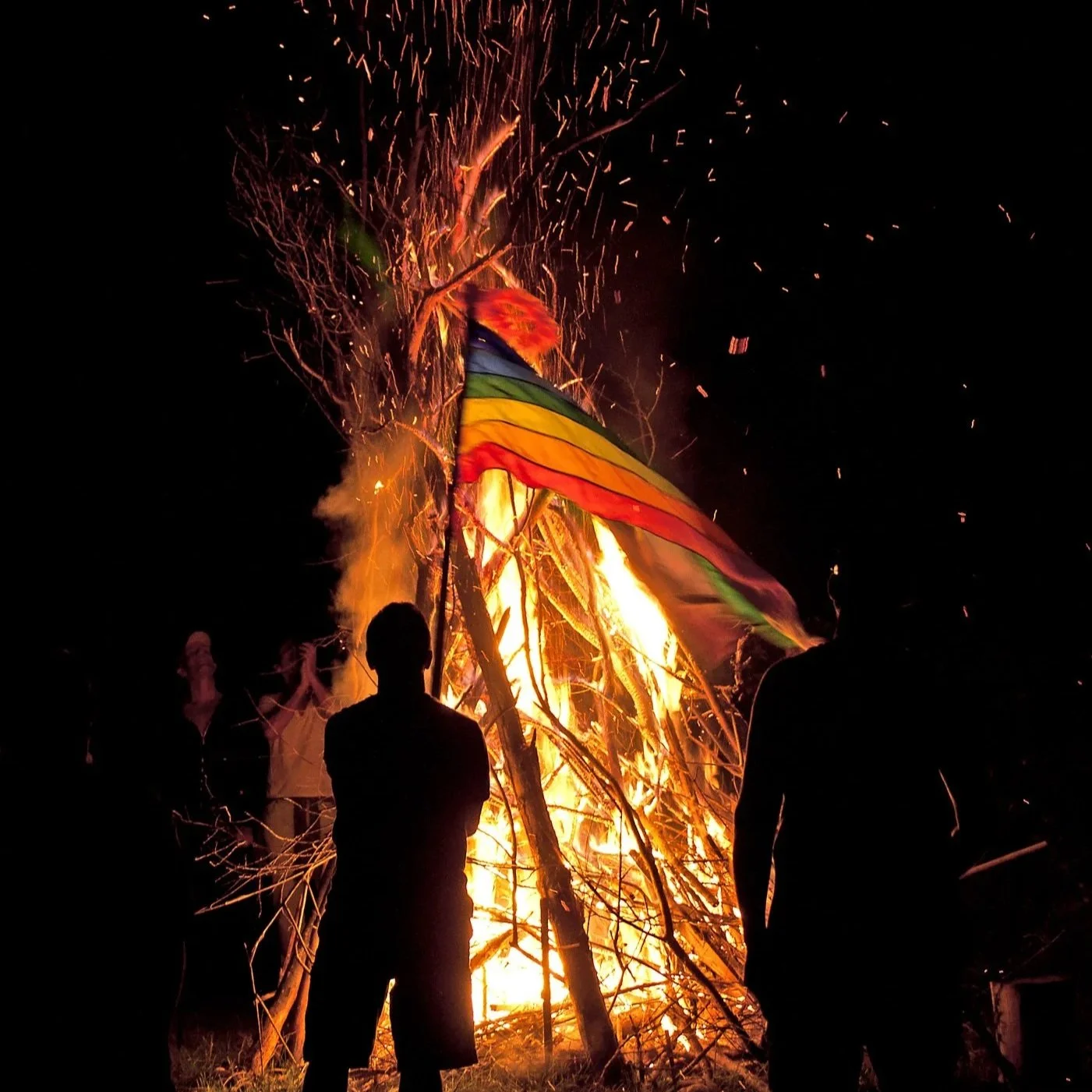 Fire ceremony with rainbow flag